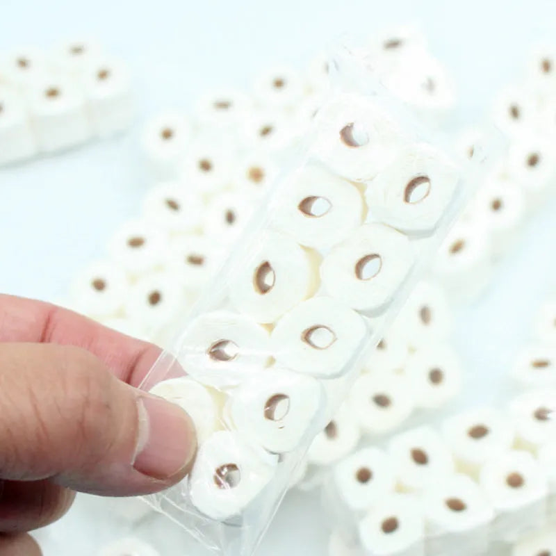 Small paper model of a tissue roll for dollhouse play, measuring 30mm by 15mm by 80mm.