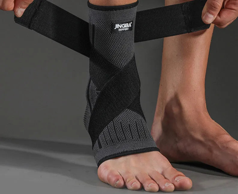 Black sports ankle support strap with Velcro fastener, shown unwrapped.