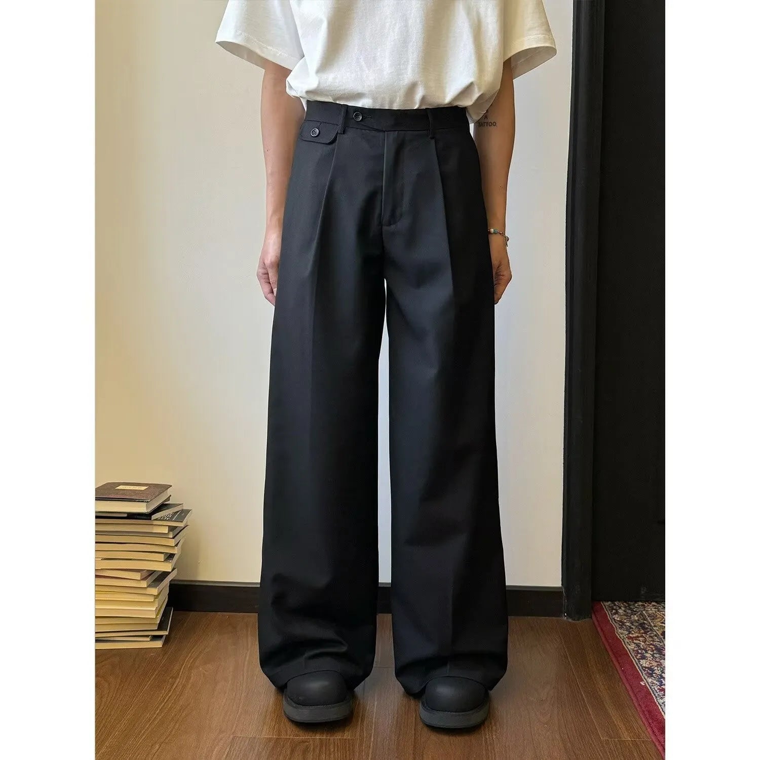 Men's straight-leg wide casual suit pants in brown solid colour, showing loose drape fit.