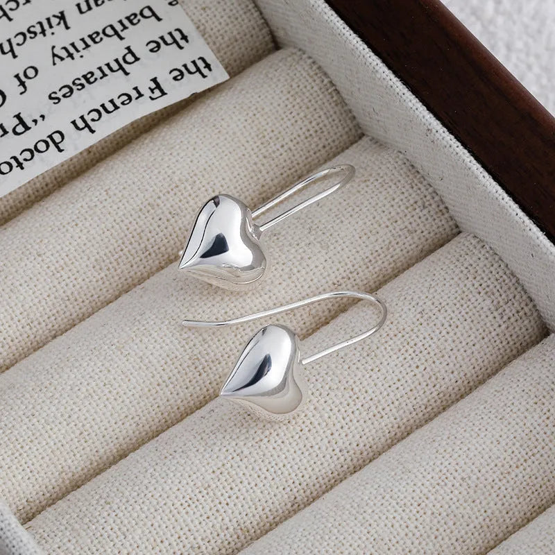 Silver Korean style heart earrings with three-dimensional glossy design and heart-shaped hooks