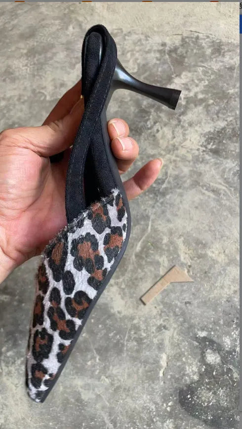 Women's leopard print suede pointed toe high-heel sandals with an adjustable ankle strap.