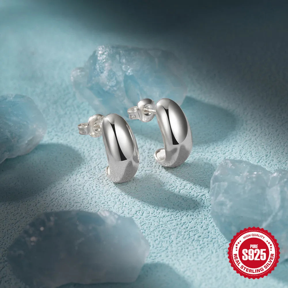 Sterling silver C-shaped geometric ring stud earrings in gold or silver tone.