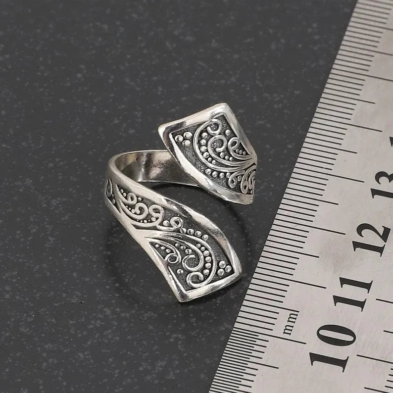 Silver-colour adjustable opening women's ring with retro minimalist design on white background