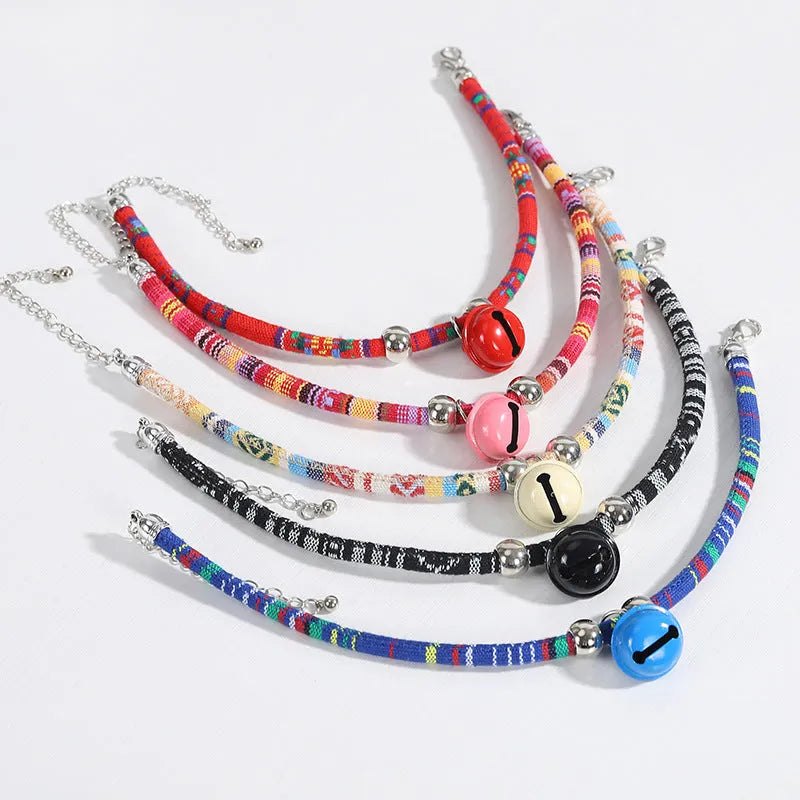 Ethnic patterned adjustable nylon pet collar with a metal buckle and bell in multiple colour options.
