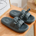 Light grey EVA flip flop slippers with a deer horn design and hollow out pattern on the upper.