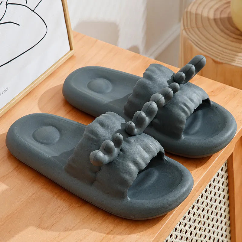 Light grey EVA flip flop slippers with a deer horn design and hollow out pattern on the upper.