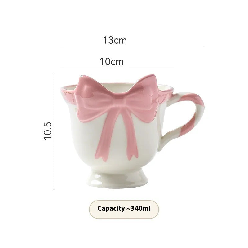Ceramic mug with bow and heart design in white powder or black pink colours