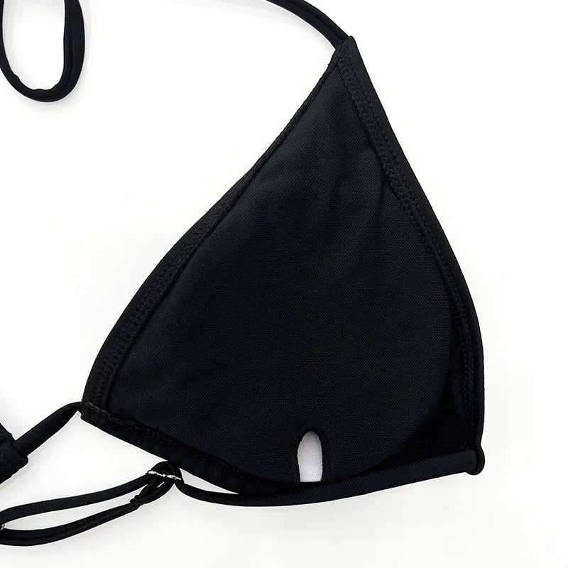 Black women's four-piece bikini swim set with long sleeves and mesh construction for swimming sports