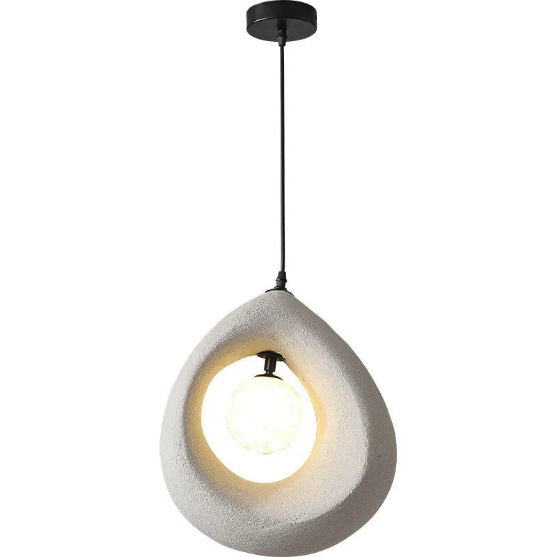 Sili Style modern pendant light with milky white glass shade in a dining room setting.