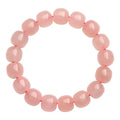 Natural pink crystal barrel bead bracelet with 8x10mm geometric beads on wrist