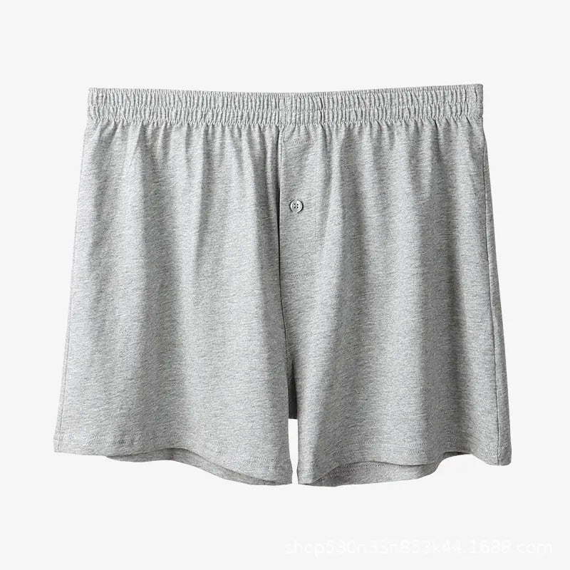 Men's high-waisted loose-fit cotton boxer shorts in black, grey, and navy blue.