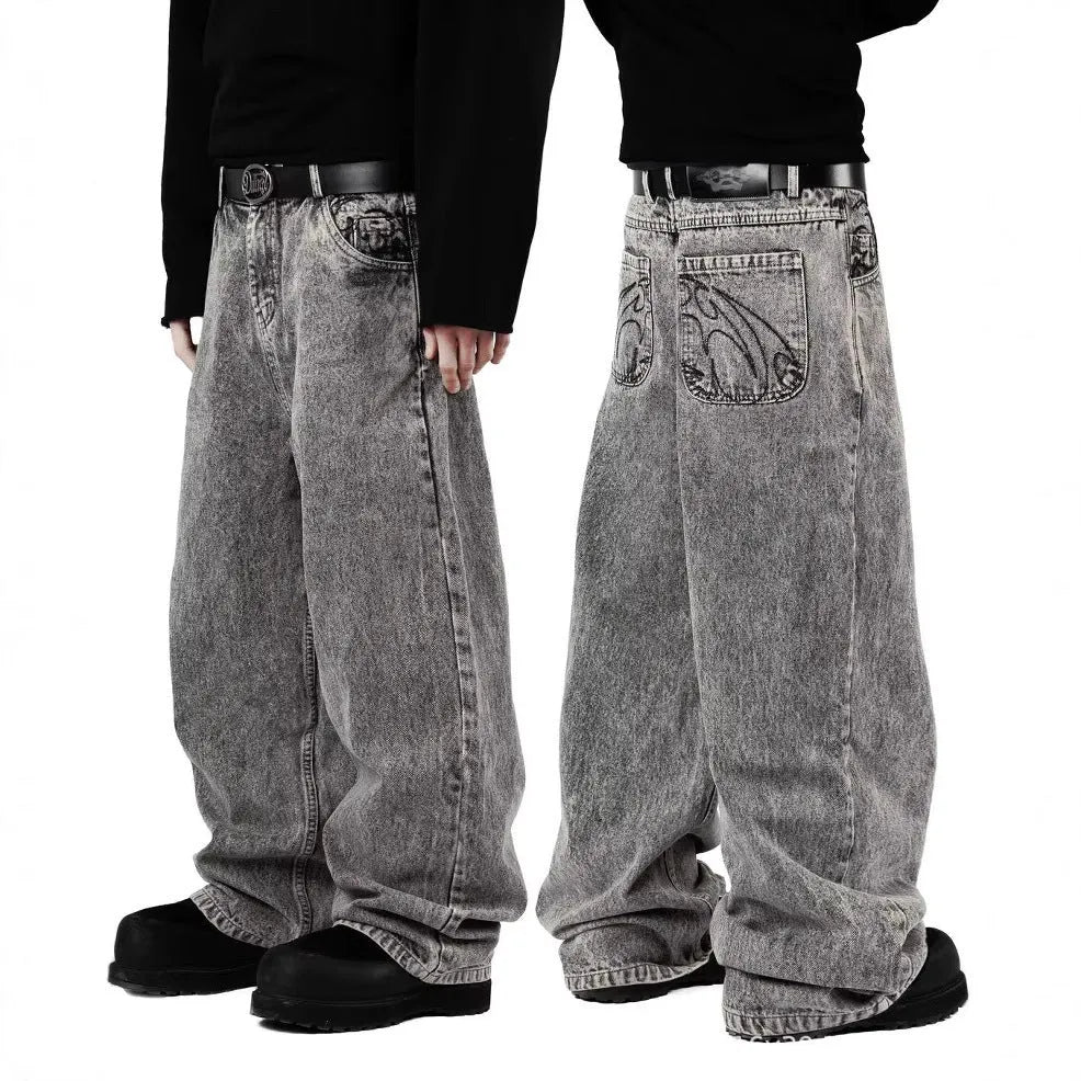 Grey loose-fit straight-leg denim trousers for men and women on a hanger.