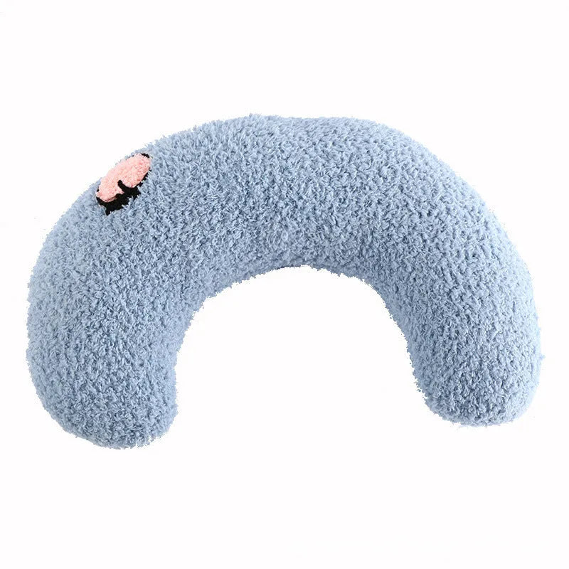Small white U-shaped plush pet pillow for cats and small dogs on a neutral background.