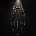 Women's gold mesh tassel hair chain with pearl decorations on dark hair