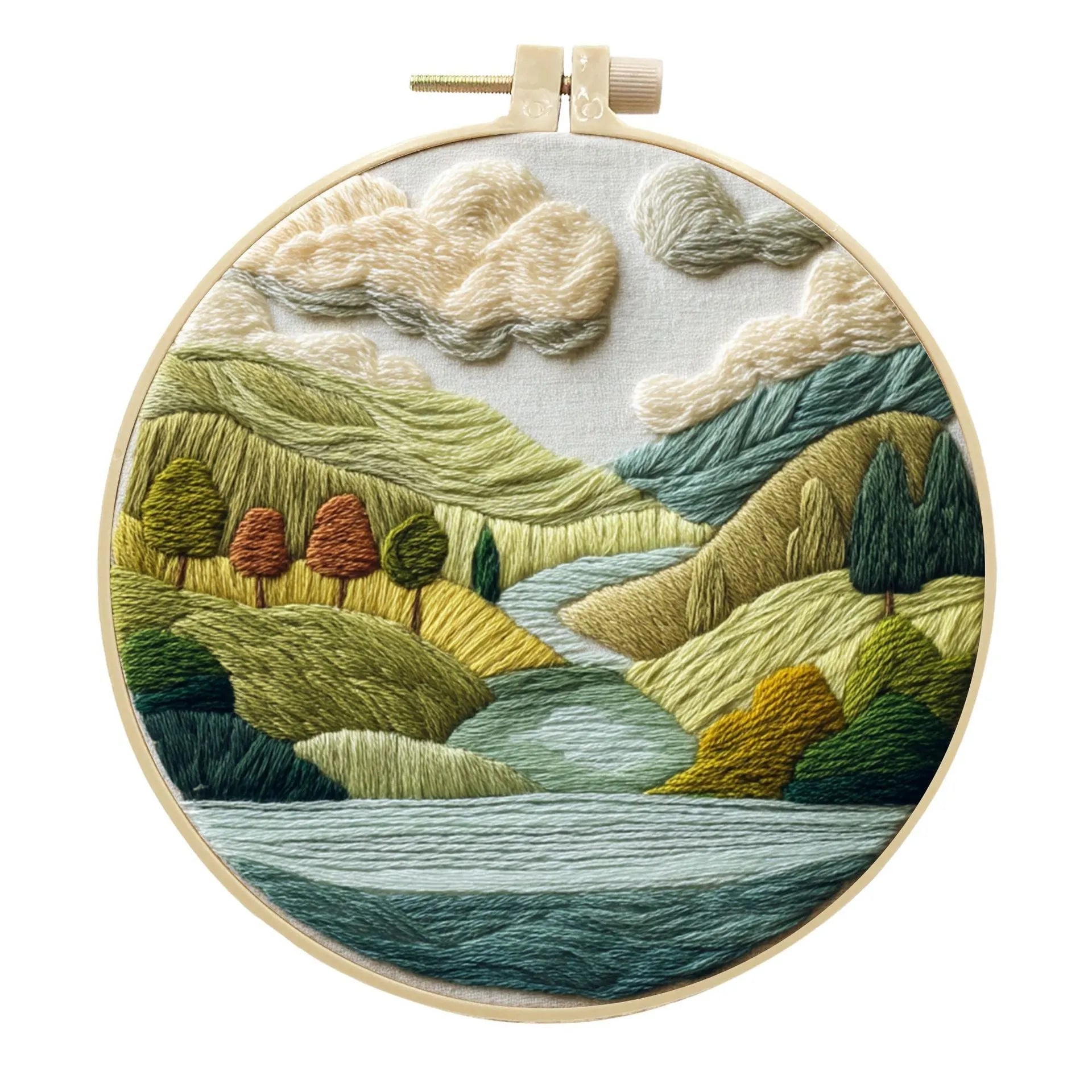 DIY embroidery kit with landscape-printed cotton fabric, embroidery hoop, needles, and coloured thread spools.