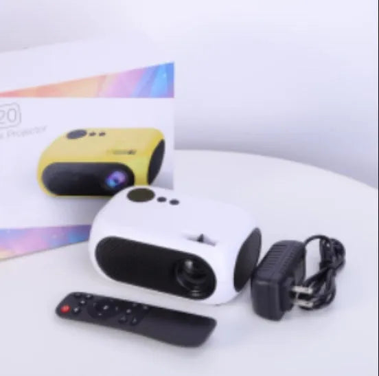 M24 Micro Mini LED Projector in Gold or White colour with power adapter and cables on a table.