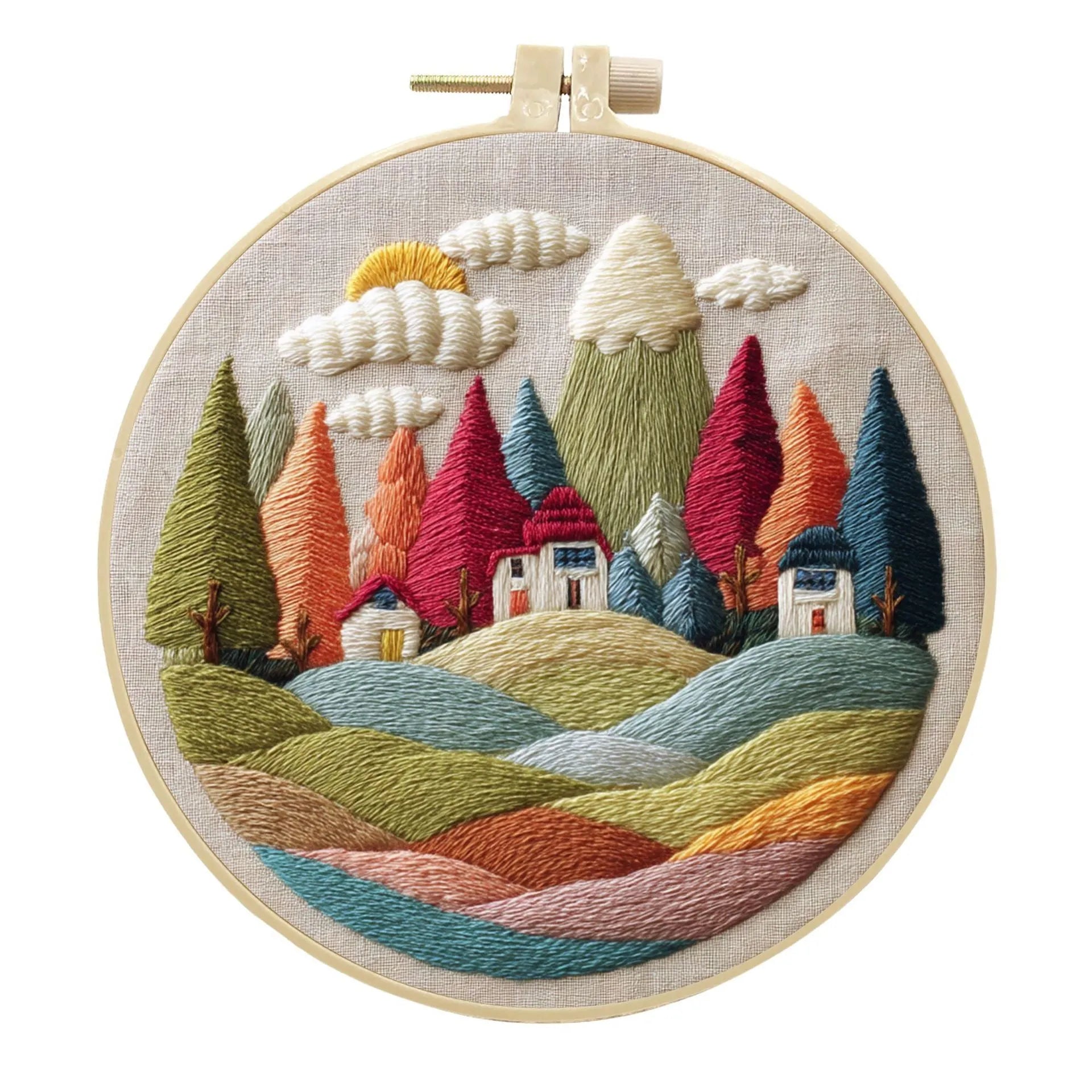 DIY embroidery kit with landscape-printed cotton fabric, embroidery hoop, needles, and coloured thread spools.
