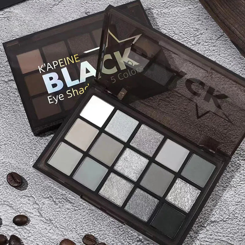 Open 15-colour eye shadow palette showing pans of brown, blue, and grey matte and shimmer shades.