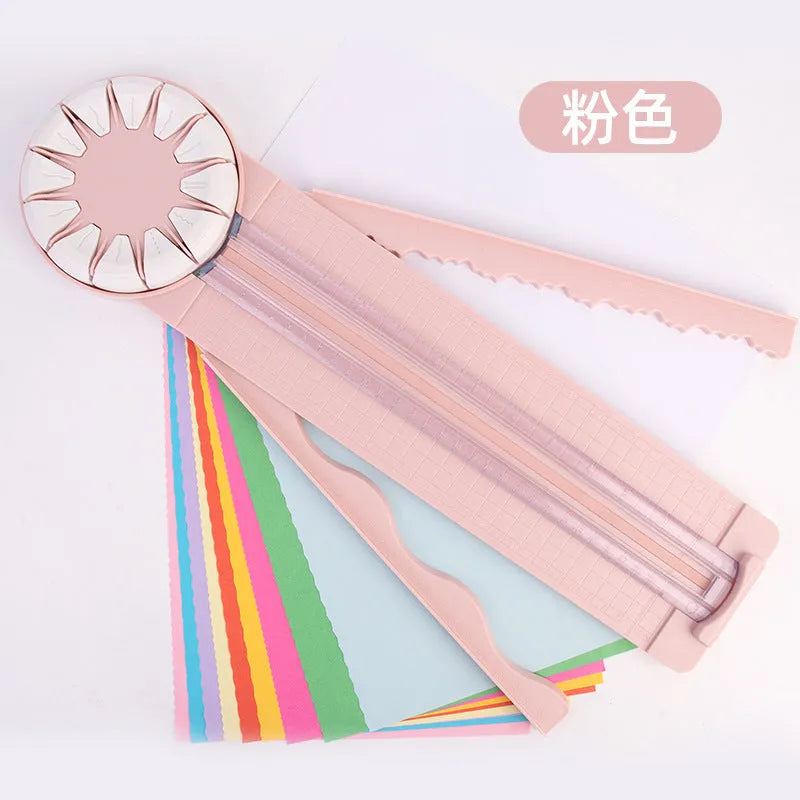 Plastic paper cutting machine with 12 multifunctional heads in pink colour on craft table