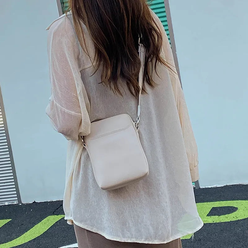 Solid colour PU leather crossbody phone bag for women shown in beige.