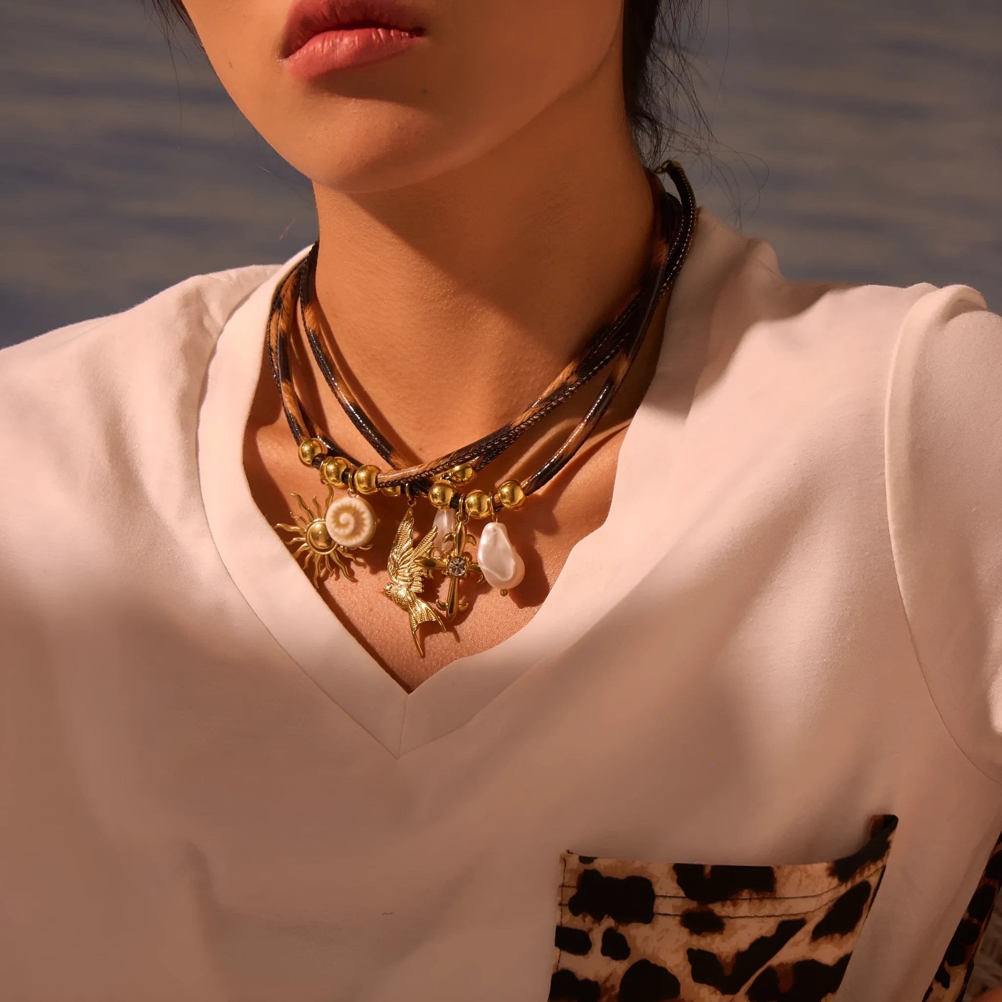 Geometric leopard print pendant on a stainless steel necklace chain with gold electroplated finish.