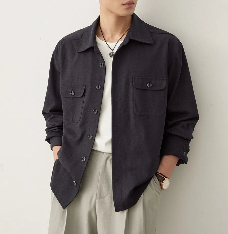 Men's simple lapel long sleeve shirt in light sand rice colour, cotton blend fabric, laid flat.