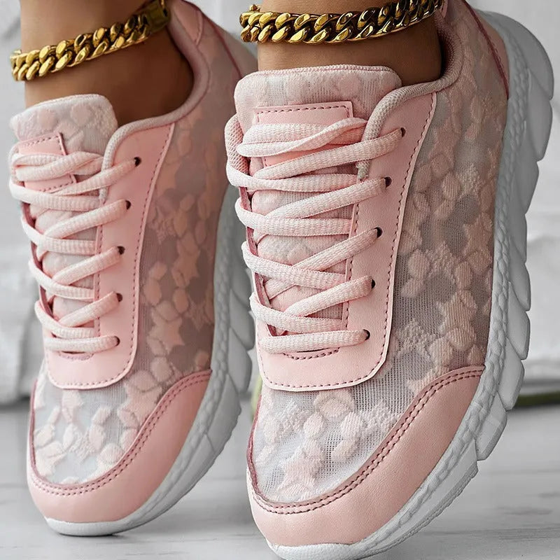 Women's canvas running shoes in white, black, blue, and pink colours with flat heel design