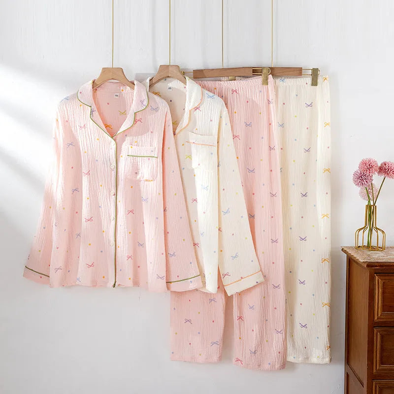 Women's cotton pajama set in pink colour with long sleeves and trousers on hanger