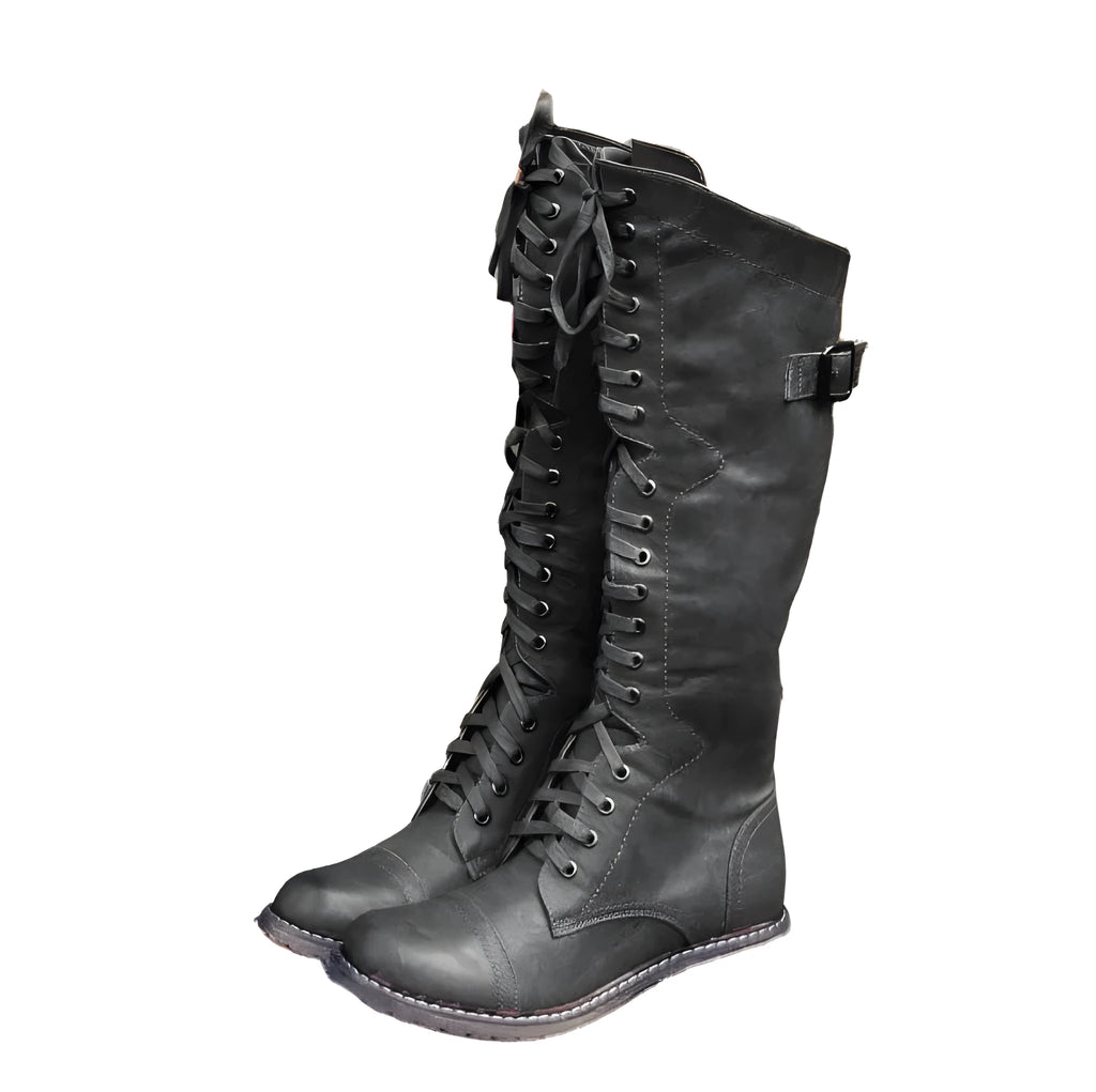 Women's black cross strap knight boots made from PU leather, showing the knee-high design and strap detail.