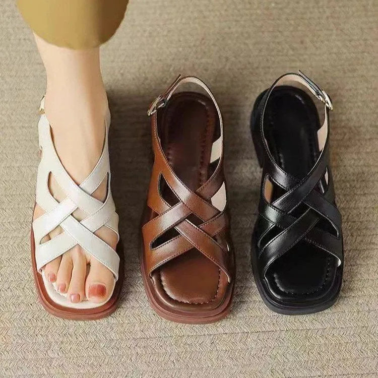 Women's glossy patent leather low heel sandals with square toe and cross-strap in black, brown and white.