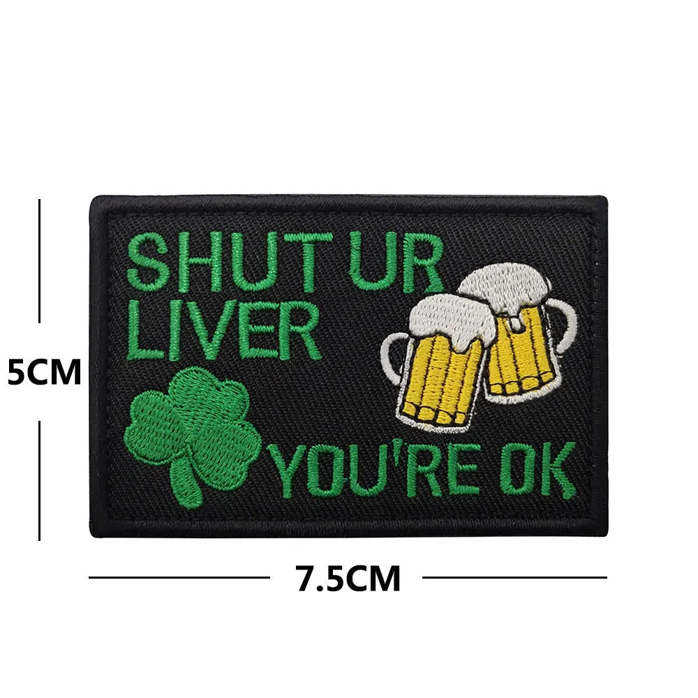 Outdoor embroidered fabric badge with Velcro strip backing on a green clover design.