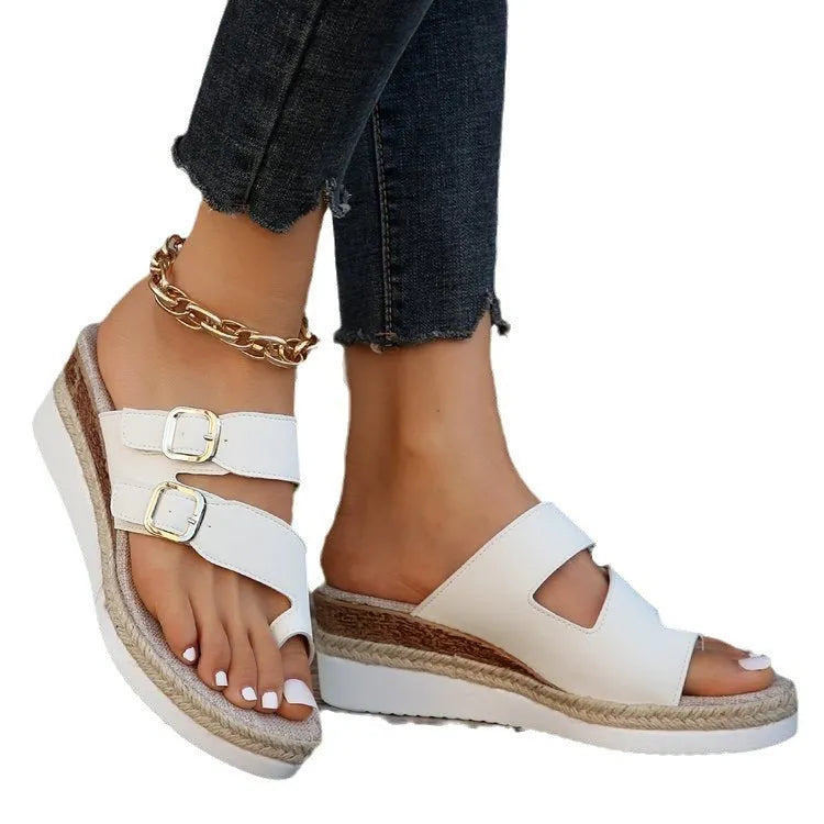 White patent leather women's wedge sandals with woven finger fit straps and a peep toe.