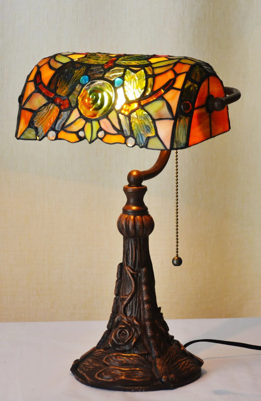 10-inch Tiffany table lamp with coloured stained glass shade and resin base on desk