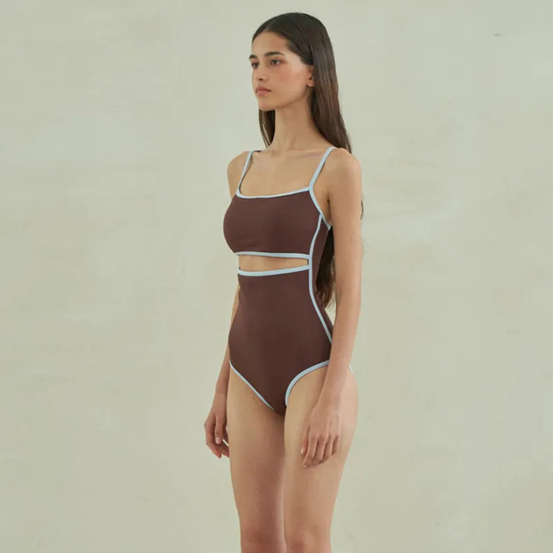 Brown triangle one-piece swimsuit for women on a hanger.