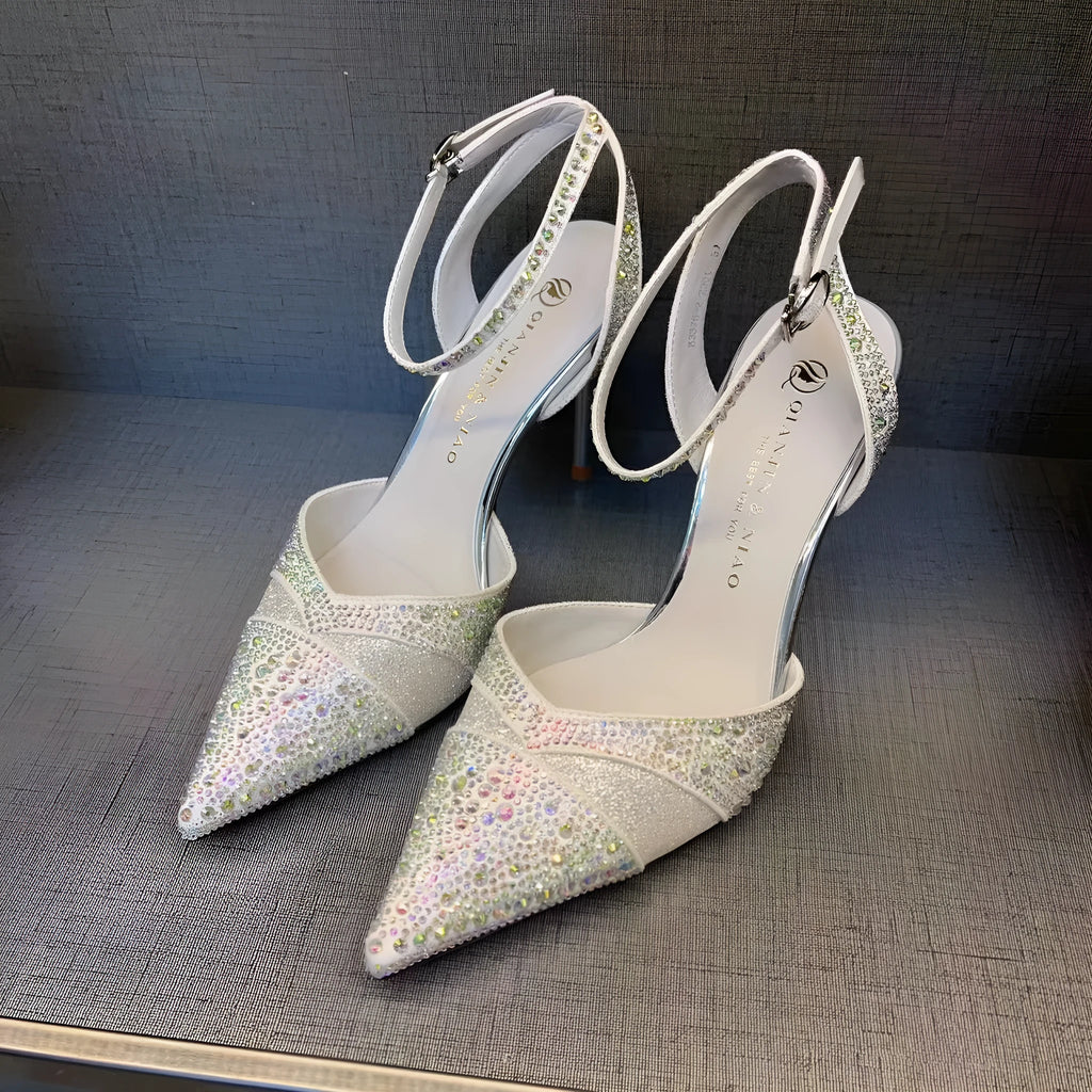 Women's black hollow high heels with red sole and pointed toe on a stiletto heel