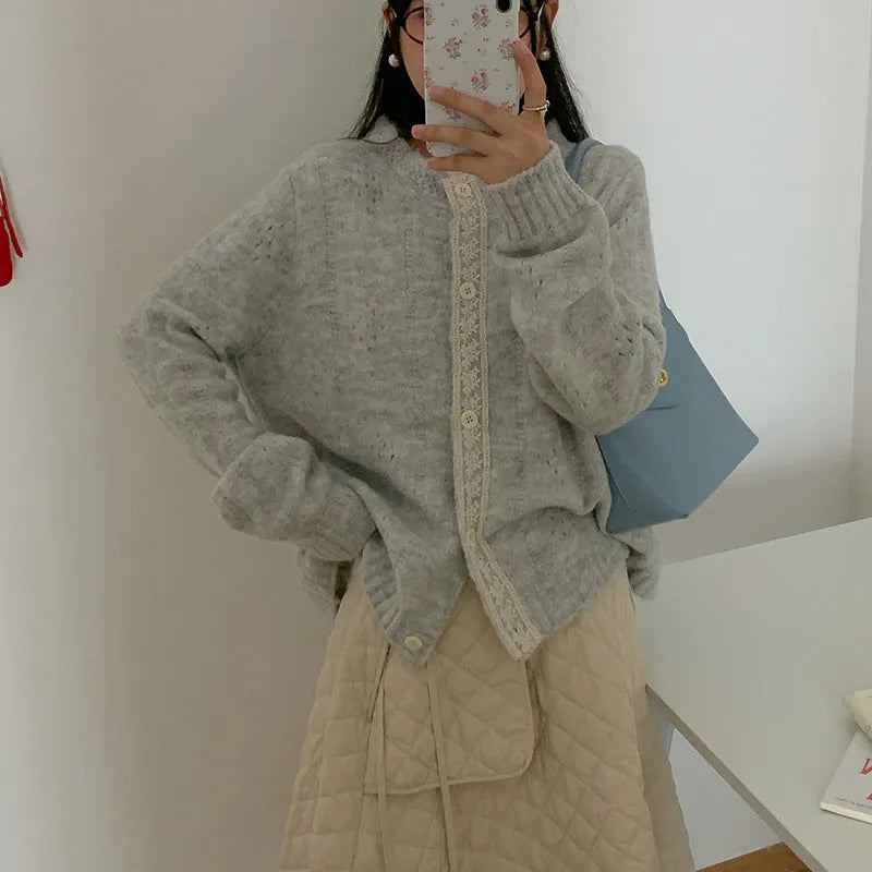 Loose apricot-coloured Korean-style cardigan sweater coat with regular sleeves on a hanger.