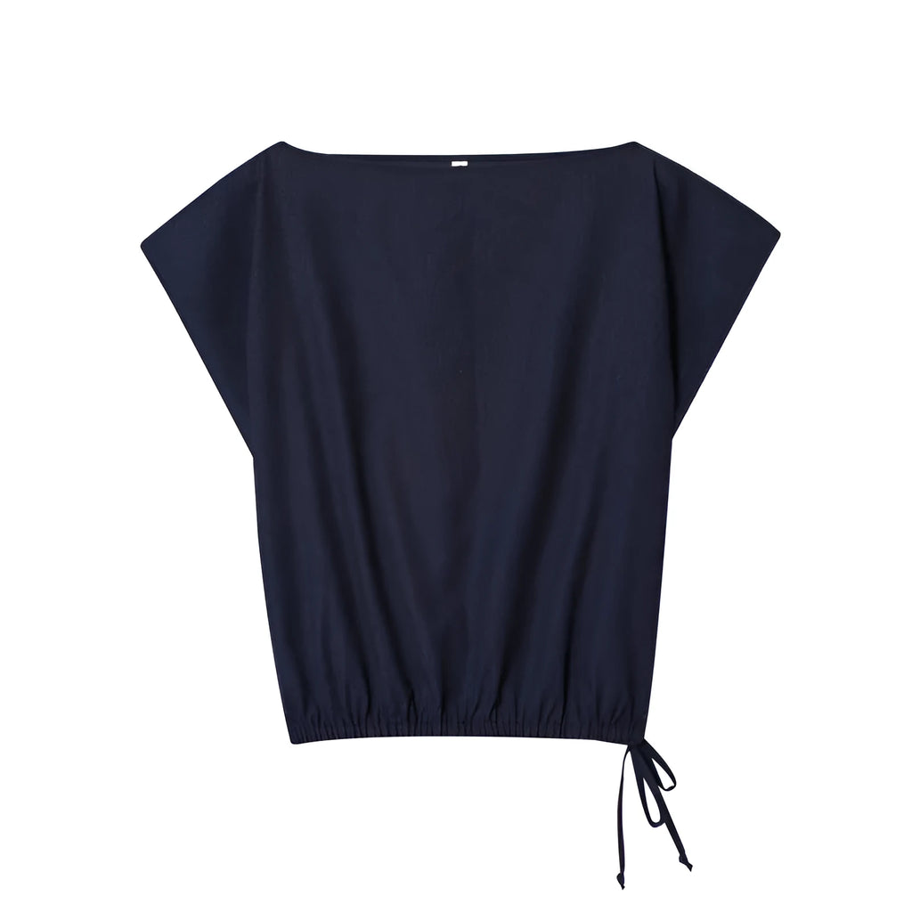 Women's linen blend two-piece set showing off-neck blouse with flounced sleeves and wide leg trousers
