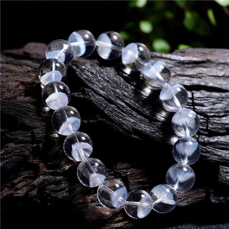 Women's natural white ghost pyramid bracelet with ground crystal beads and Ruyi design element