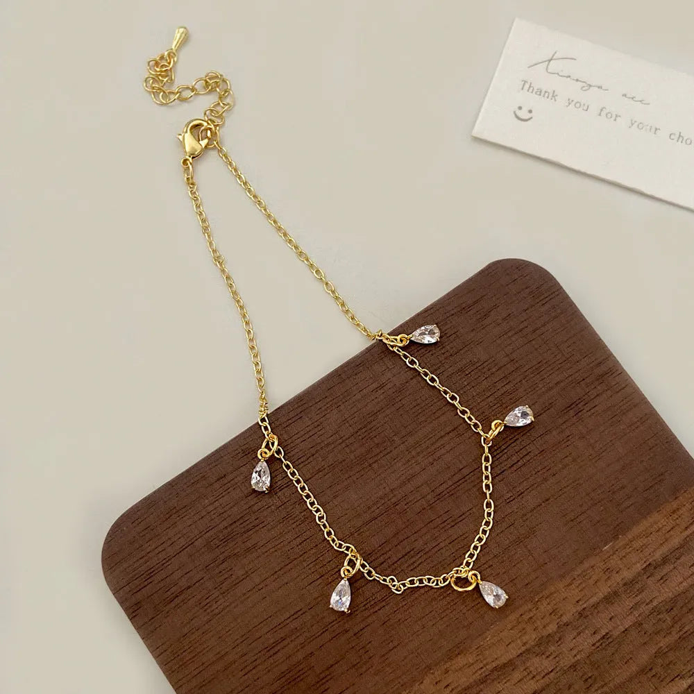 Women's zircon necklace set with matching geometric earrings and anklet featuring meteor shower pattern