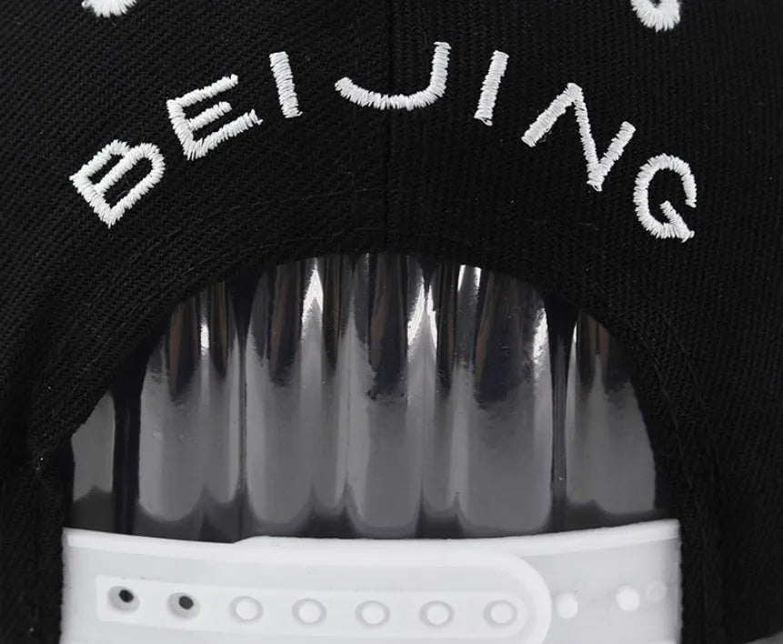 Letter-embroidered cotton baseball hat with adjustable strap in black and white colour options