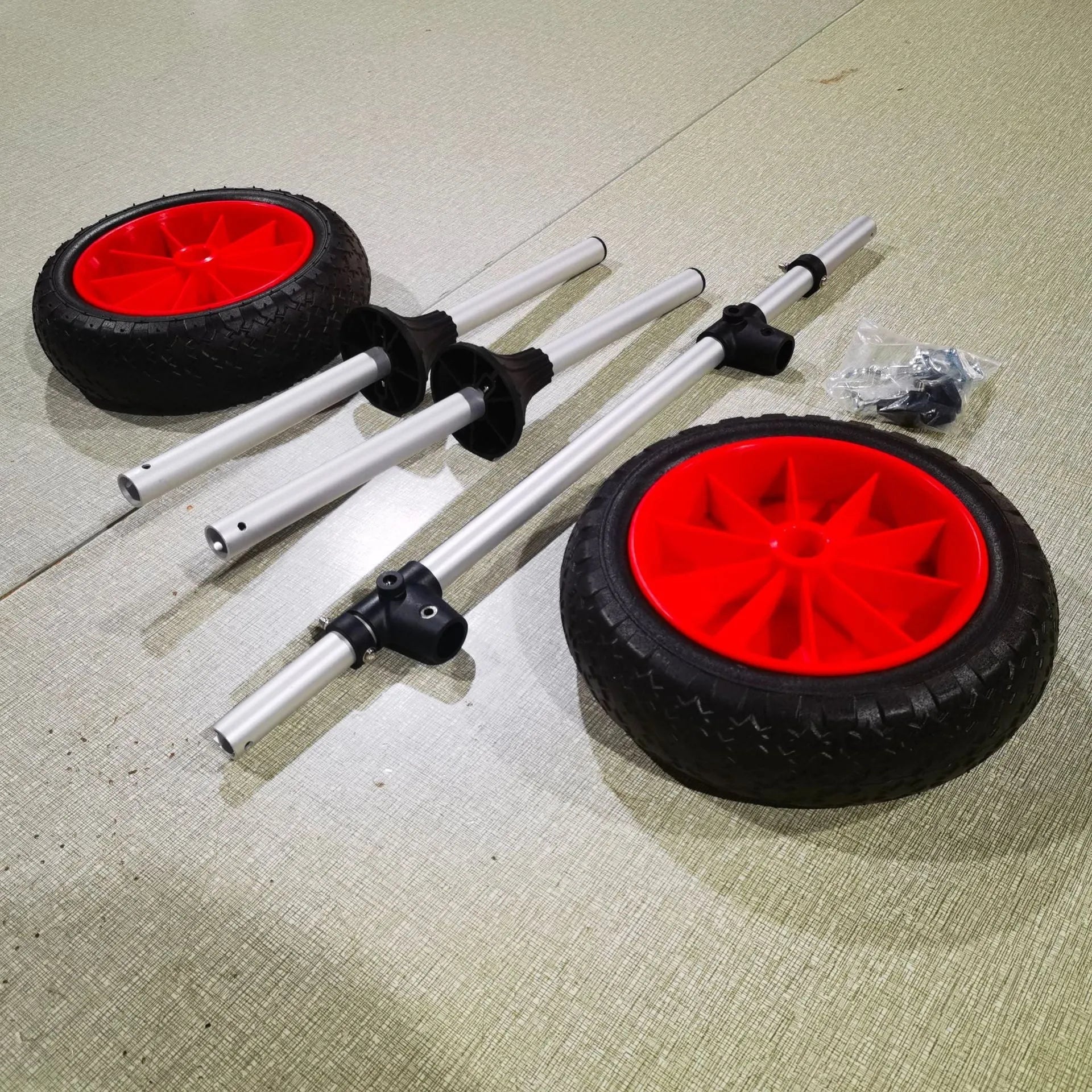 Foldable kayak beach trailer with aluminium frame and rubberised cradle for open kayak transport