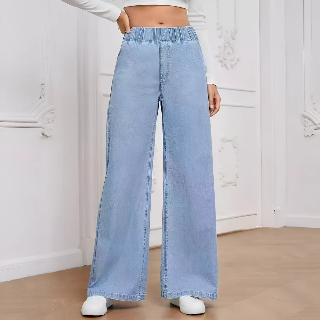 Light blue washed wide-leg denim trousers on a hanger, showing straight cut and zip front.