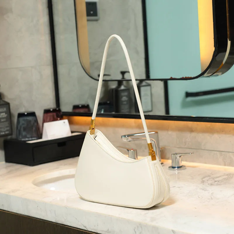 Women's oval shaped underarm bag in PU leather with single shoulder strap and internal zipper compartment