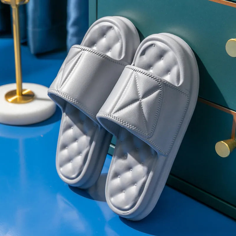 A pair of thick-soled EVA bathroom slippers in a selected colour, showing the non-slip sole pattern.