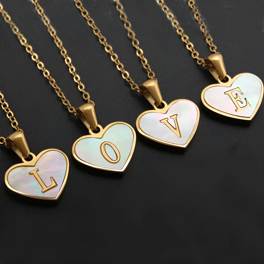 Gold plated heart pendant necklace with white shell centre on a stainless steel chain.