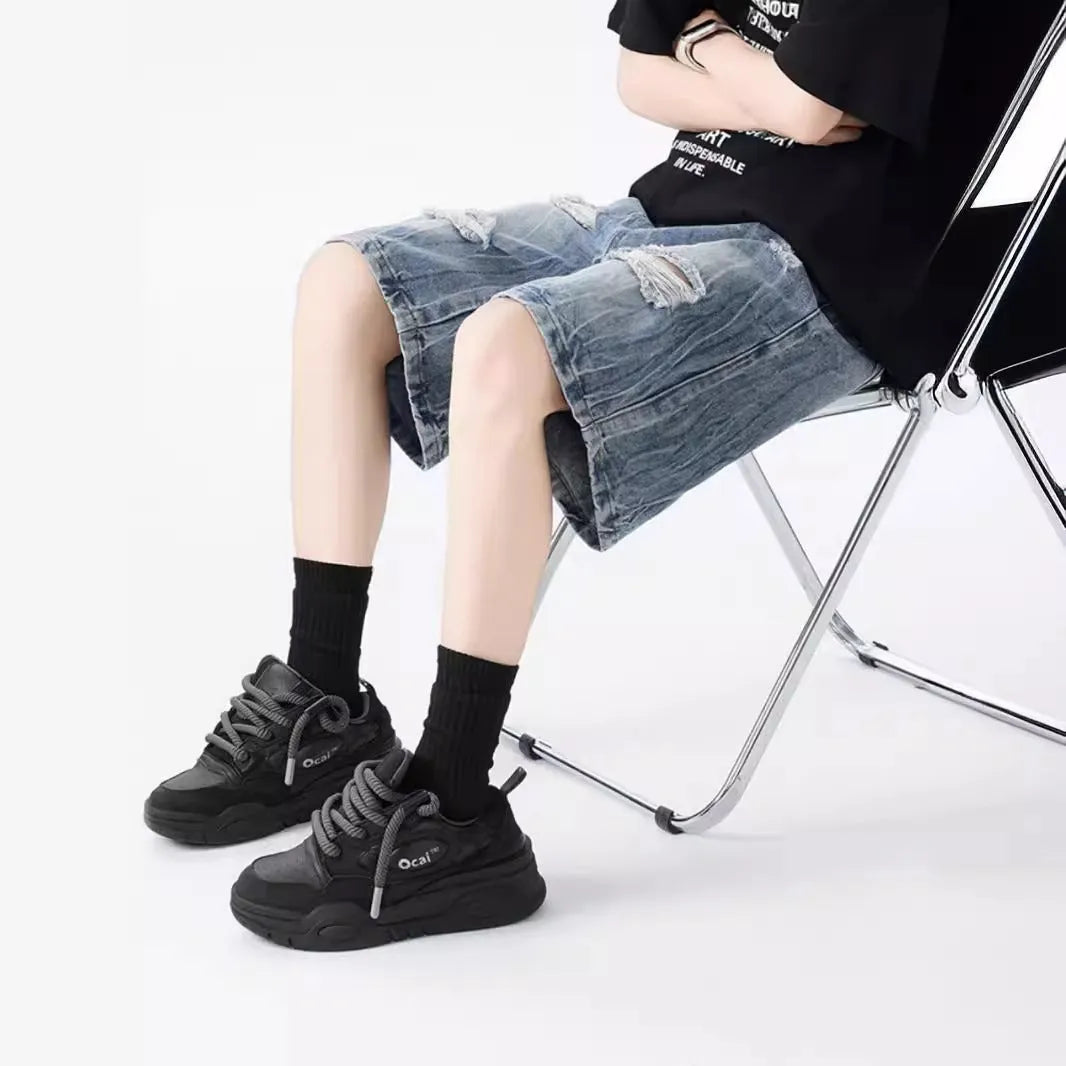 Washed denim shorts with ripped detailing in loose retro fit, black and blue colour options