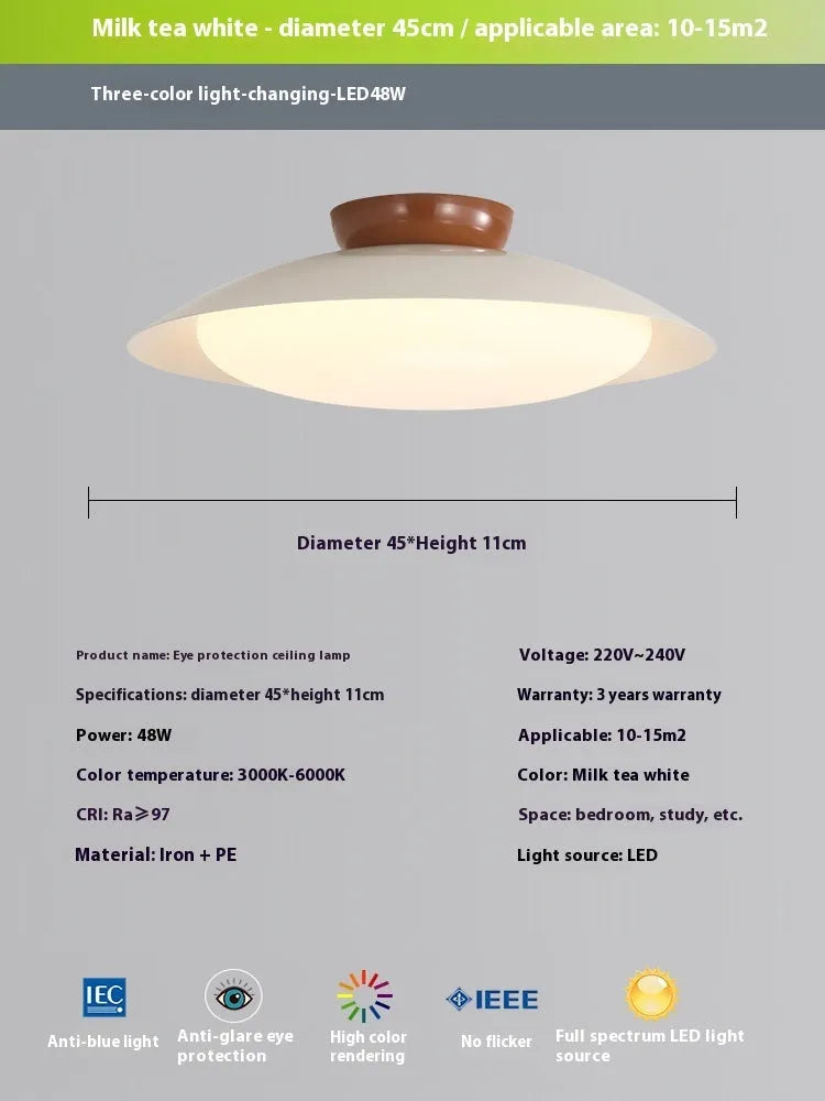 Modern cream-style flying saucer shaped ceiling lamp in a bedroom setting.