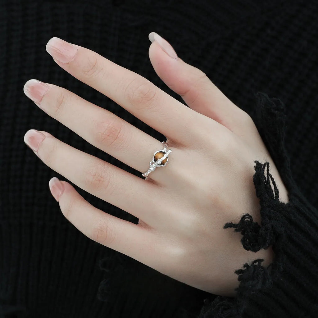White gold coloured Saturn open ring with adjustable sizing on silver base