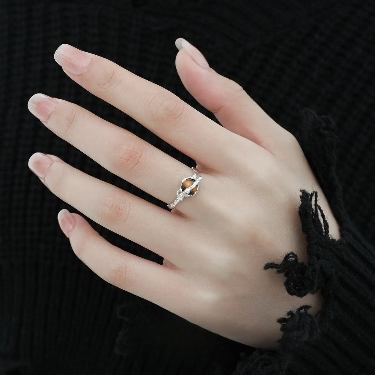 White gold coloured Saturn open ring with adjustable sizing on silver base