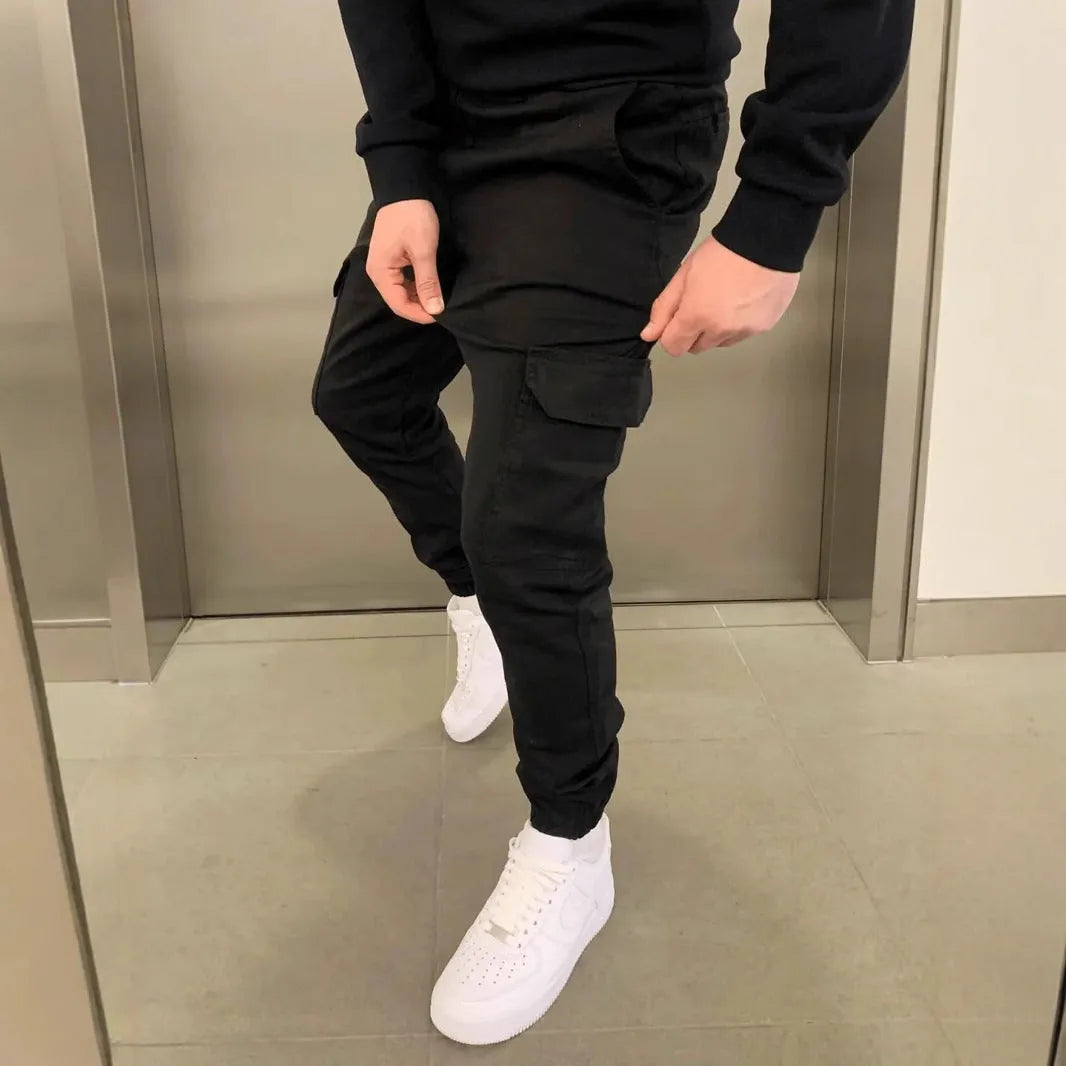 Men's loose polyester trousers with patch pockets and elastic waistband in light blue colour